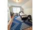 This bedroom has white paneled walls, blue patterned carpet, and a window to let in natural light at 206 23Rd Nw St, Hickory, NC 28601