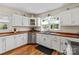 Bright kitchen features white cabinets, wood countertops, stainless steel appliances, and hardwood floors at 206 23Rd Nw St, Hickory, NC 28601