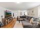 Spacious living room with a large sectional sofa, hardwood floors, and a mountain view TV at 206 23Rd Nw St, Hickory, NC 28601