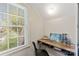 This office has a wood desk by the window and white walls with paneling on them at 206 23Rd Nw St, Hickory, NC 28601