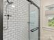 Shower features white subway tile, glass door, and modern fixtures with a window on the side wall at 206 23Rd Nw St, Hickory, NC 28601