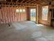 New construction basement with pink insulation, sliding glass door, and multiple window views at 2212 Indigo Branch Rd, Indian Land, SC 29707