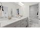This bright, modern bathroom features dual sinks, shaker cabinets, and a tub-shower with decorative tile at 2212 Indigo Branch Rd, Indian Land, SC 29707