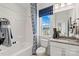 This bathroom features a shower-tub combo, decorative shower curtain, granite vanity, and a bright window at 2212 Indigo Branch Rd, Indian Land, SC 29707