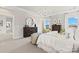Bright bedroom features a round mirror, a large dresser, and comfortable furnishings at 2212 Indigo Branch Rd, Indian Land, SC 29707