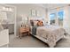 This bright bedroom has lots of natural light from the window, a cozy bed and a peach colored nightstand at 2212 Indigo Branch Rd, Indian Land, SC 29707