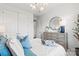 Bright bedroom features neutral tones, modern lighting, dresser with mirror, and a comfortable bed at 2212 Indigo Branch Rd, Indian Land, SC 29707