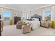 Spacious bedroom featuring a decorative headboard, two chairs, and three bright windows at 2212 Indigo Branch Rd, Indian Land, SC 29707