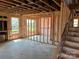 Interior shot of new construction with insulation, staircase, and open floor plan with window views at 2212 Indigo Branch Rd, Indian Land, SC 29707