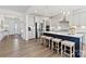 Spacious kitchen with stainless steel appliances, a large island with seating, and modern pendant lighting at 2212 Indigo Branch Rd, Indian Land, SC 29707