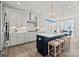 Bright kitchen features white cabinets, stainless steel appliances, a spacious island, and modern pendant lighting at 2212 Indigo Branch Rd, Indian Land, SC 29707
