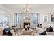 Bright living room with fireplace, modern light fixture, and neutral decor at 2212 Indigo Branch Rd, Indian Land, SC 29707
