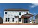 Rear view of new construction home with a covered patio area and large windows under a clear sky at 2212 Indigo Branch Rd, Indian Land, SC 29707