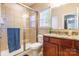 Modern bathroom showcases a glass-enclosed shower, granite countertop, and a cherry wood vanity at 2610 Mchanna Pt, Fort Mill, SC 29708