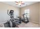 Bedroom with a carpeted floor featuring an elliptical machine, treadmill, bench and a window at 2610 Mchanna Pt, Fort Mill, SC 29708