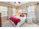 Bedroom with a wood-framed bed, two windows with blinds and curtains, carpeted floor and ceiling fan at 2610 Mchanna Pt, Fort Mill, SC 29708