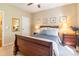 Cozy bedroom features a classic wooden bed frame, complemented by framed artwork and a neutral color palette at 2610 Mchanna Pt, Fort Mill, SC 29708