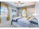 Comfortable bedroom with gray and white walls, a ceiling fan and two windows with yellow curtains at 2610 Mchanna Pt, Fort Mill, SC 29708