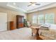 Serene primary bedroom with a tray ceiling, large windows, and comfortable seating area at 2610 Mchanna Pt, Fort Mill, SC 29708
