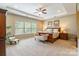 Bright main bedroom with a tray ceiling, large windows, and stylish furniture at 2610 Mchanna Pt, Fort Mill, SC 29708
