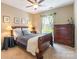 Comfortable bedroom boasts a decorative ceiling fan, natural light from the window, and a well-appointed furnishings at 2610 Mchanna Pt, Fort Mill, SC 29708