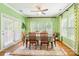 Sunlit dining room featuring hardwood floors, green walls, and a large dining table with seating for six at 2610 Mchanna Pt, Fort Mill, SC 29708