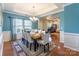 Bright and elegant dining room with a tray ceiling, chandelier, and a view into the office space at 2610 Mchanna Pt, Fort Mill, SC 29708
