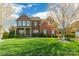 Charming two-story brick home with a manicured lawn and inviting front porch, showcasing curb appeal at 2610 Mchanna Pt, Fort Mill, SC 29708