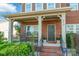Inviting front porch with classic columns, decorative plants, and a welcoming entrance to the home at 2610 Mchanna Pt, Fort Mill, SC 29708