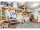 Well-organized garage featuring storage shelves, a workbench, tools and a refrigerator at 2610 Mchanna Pt, Fort Mill, SC 29708