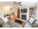 Cozy living room featuring a fireplace, built-in shelving, and comfortable seating area with hardwood floors at 2610 Mchanna Pt, Fort Mill, SC 29708