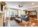 Spacious living room featuring hardwood floors, a large gray sectional sofa, and views into the kitchen at 2610 Mchanna Pt, Fort Mill, SC 29708