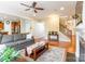 Open-concept living room with hardwood floors, staircase view, and access to the kitchen at 2610 Mchanna Pt, Fort Mill, SC 29708