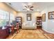 Comfortable home office with a ceiling fan, bookshelves, and a cozy seating area at 2610 Mchanna Pt, Fort Mill, SC 29708