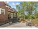 Backyard featuring stone steps, a landscaped area, brick exterior, and a rocking chair at 2731 Laugenour Pl, Kannapolis, NC 28081
