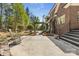Backyard featuring stone steps, a landscaped area, brick exterior, and a rocking chair at 2731 Laugenour Pl, Kannapolis, NC 28081