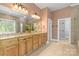 Elegant bathroom featuring a double vanity, tiled floors, and natural light from the window at 2731 Laugenour Pl, Kannapolis, NC 28081