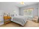 Bedroom featuring a bed with gray and white check patterned bedding, beige carpet, and chair at 2731 Laugenour Pl, Kannapolis, NC 28081
