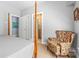 Bedroom with a carved four poster bed, patterned armchair, and ensuite bathroom access at 2731 Laugenour Pl, Kannapolis, NC 28081