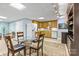 Basement dining area with a glass table, kitchen, and adjacent casual seating at 2731 Laugenour Pl, Kannapolis, NC 28081