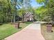 Charming brick home with American flag, mature trees, and a well-manicured lawn at 2731 Laugenour Pl, Kannapolis, NC 28081