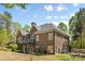 Spacious backyard featuring the home's brick exterior, a balcony, and verdant landscaping at 2731 Laugenour Pl, Kannapolis, NC 28081