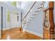 Grand foyer featuring a staircase, hardwood floors, and natural light creating a bright, welcoming atmosphere at 2731 Laugenour Pl, Kannapolis, NC 28081
