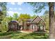 Stunning two-story brick home with a lush green lawn and mature trees, offering curb appeal at 2731 Laugenour Pl, Kannapolis, NC 28081