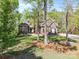 Beautiful brick home with well-manicured lawn, surrounded by trees, enhancing its peaceful setting at 2731 Laugenour Pl, Kannapolis, NC 28081
