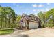 Spacious three-car garage with a brick facade, seamlessly blending functionality with the home's design at 2731 Laugenour Pl, Kannapolis, NC 28081