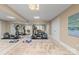 Bright home gym with mirrored wall and exercise equipment and an area rug at 2731 Laugenour Pl, Kannapolis, NC 28081