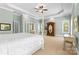 Large main bedroom with tray ceilings, four-poster bed, and access to the ensuite bathroom at 2731 Laugenour Pl, Kannapolis, NC 28081