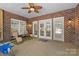 Covered patio with brick floor, ceiling fan, multiple windows and chairs at 2731 Laugenour Pl, Kannapolis, NC 28081
