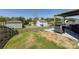A backyard view shows a grassy area, fence, and patio with outdoor cooking setup at 325 Crandon Rd, Mount Holly, NC 28120